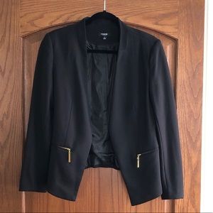 Women’s black blazer with gold zipper pockets